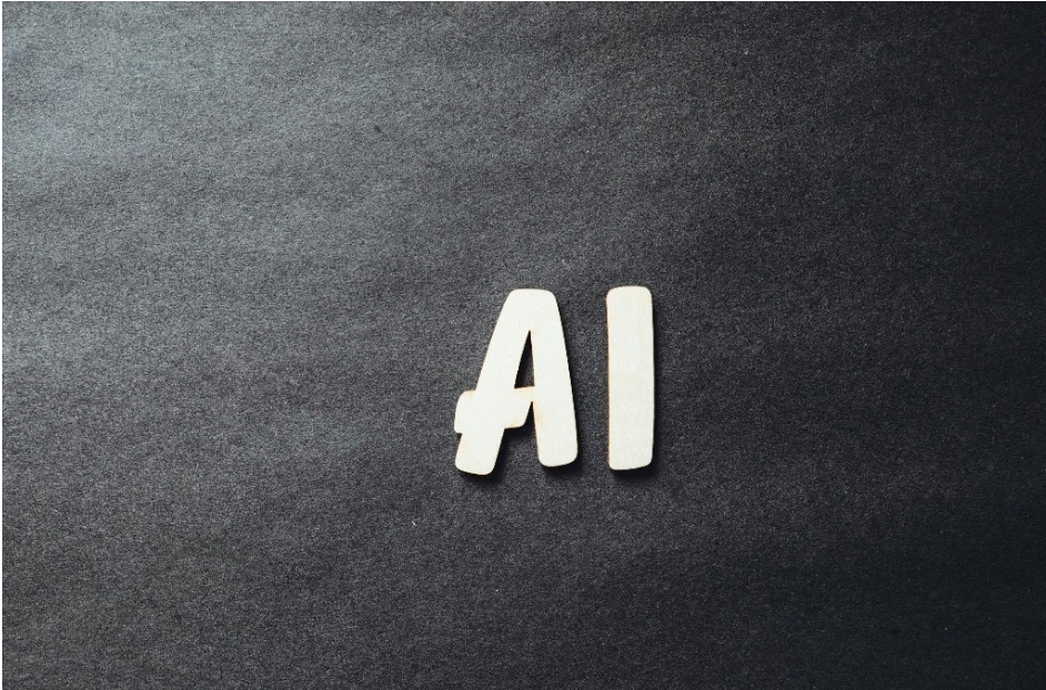 a palavra “AI” escrita em letras brancas em uma superfície escura 